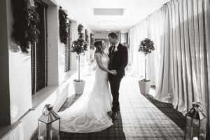 bride-groom-backlit-white-corridor