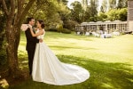 A bride and groom embrace after their wedding in the gardens of the Maryborough Hotel in Cork